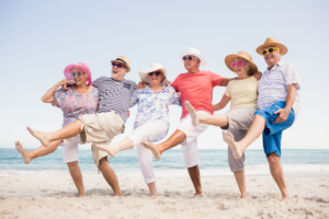 Happy seniors dancing on the beach.